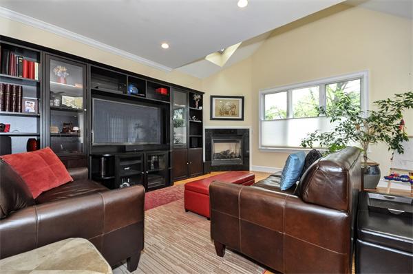 86 McCarthy Road Newton, MA 02459 - Photo 11 of 29 a living room with furniture a large window and a flat screen tv