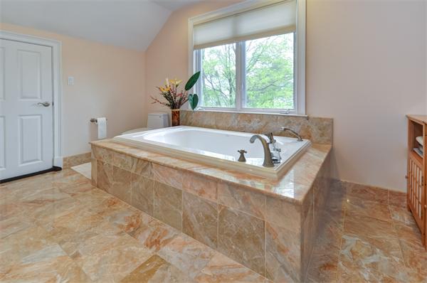 86 McCarthy Road Newton, MA 02459 - Photo 21 of 29 a spacious bathroom with a bathtub and window