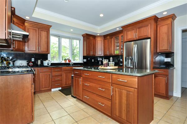 86 McCarthy Road Newton, MA 02459 - Photo 6 of 29 a kitchen with stainless steel appliances granite countertop a refrigerator oven a sink dishwasher and wooden cabinets with a granite countertops