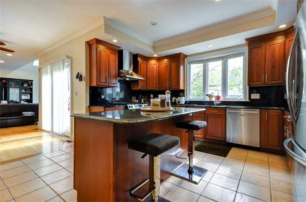 86 McCarthy Road Newton, MA 02459 - Photo 7 of 29 a kitchen with stainless steel appliances kitchen island granite countertop a sink counter space and a large window