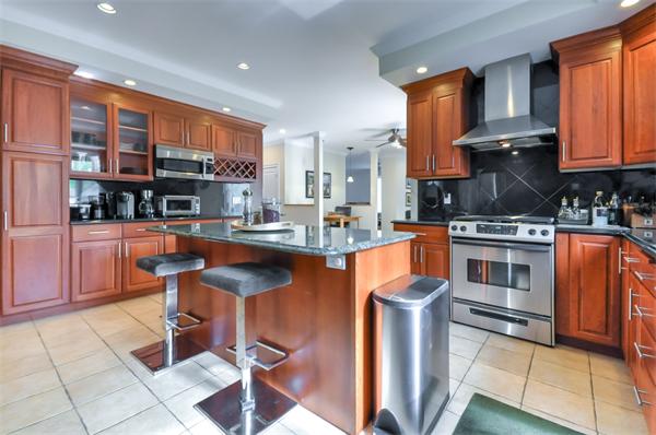 86 McCarthy Road Newton, MA 02459 - Photo 8 of 29 a kitchen with stainless steel appliances granite countertop a stove a sink and a microwave