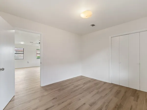 a bathroom with a double vanity sink toilet mirror and bathtub