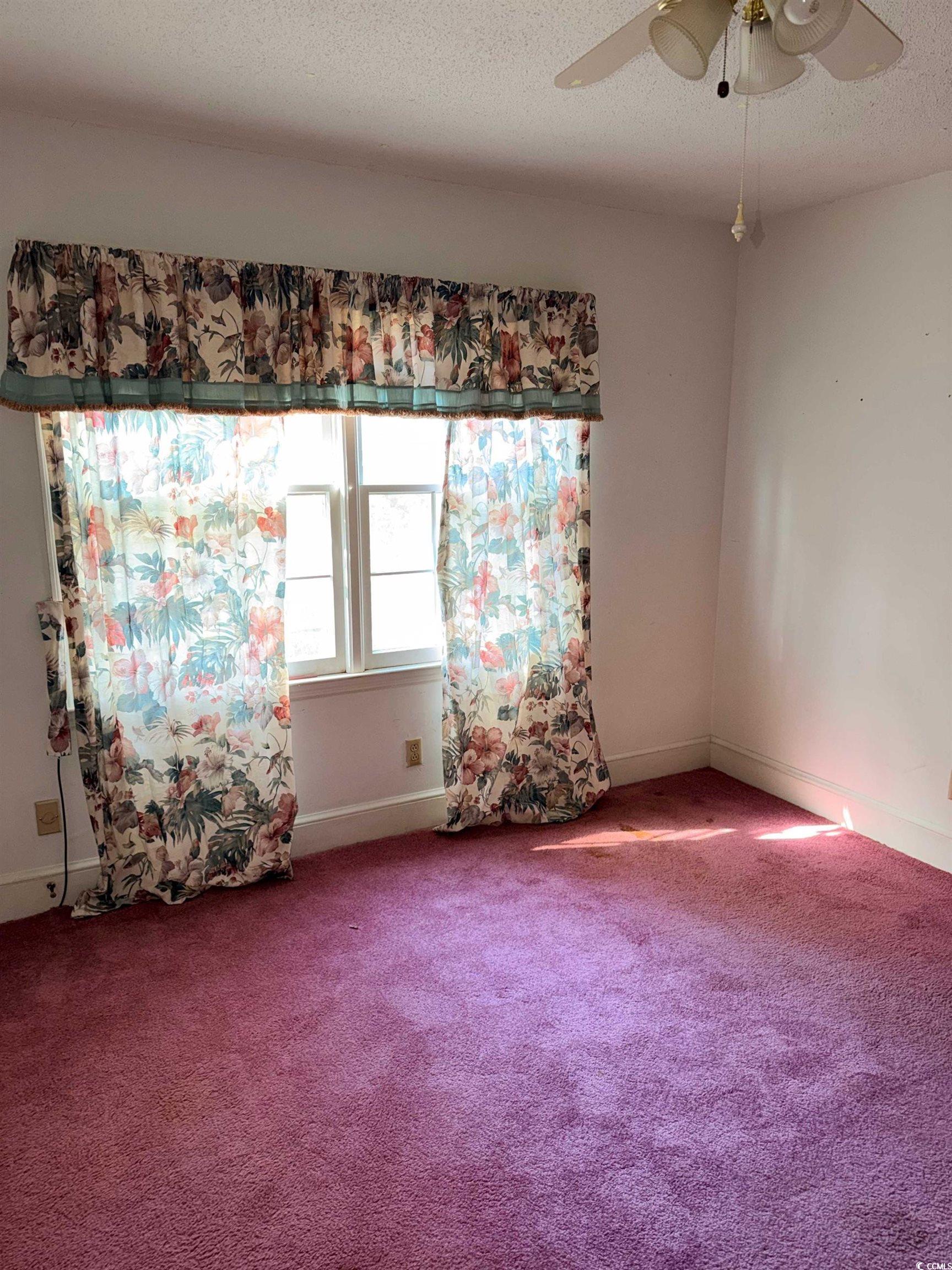 1320 Horseshoe Road Mullins, SC 29574 - Photo 18 of 22 Carpeted spare room featuring baseboards and a textured ceiling