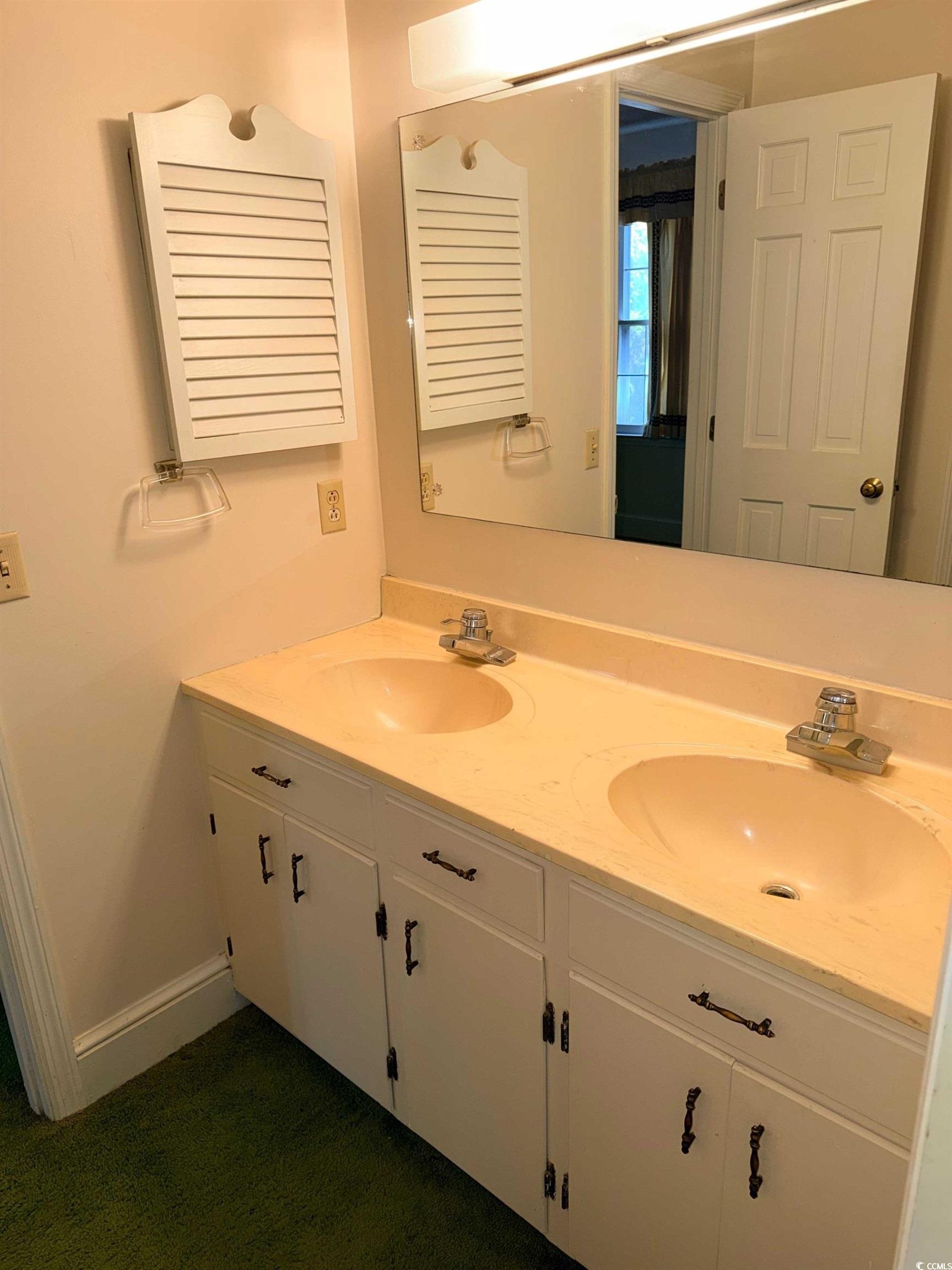 1320 Horseshoe Road Mullins, SC 29574 - Photo 20 of 22 Unfurnished living room with a textured ceiling, a fireplace, beamed ceiling, carpet floors, and wooden walls