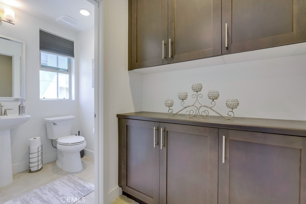 104 Alder Ridge Lake Forest, CA 92610 - Photo 21 of 74 a bathroom with a granite countertop sink a mirror and toilet