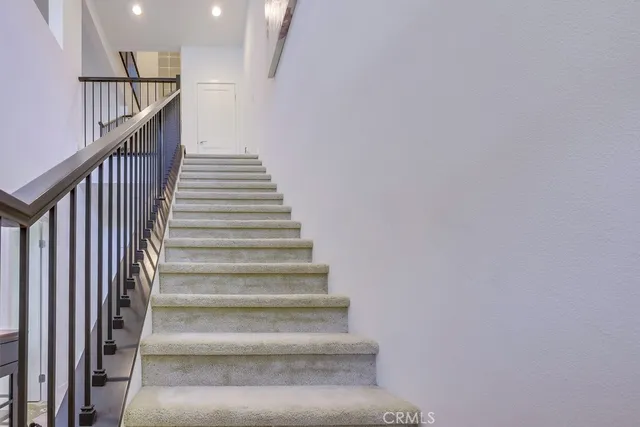 a bedroom with a bed and a lamp on dresser