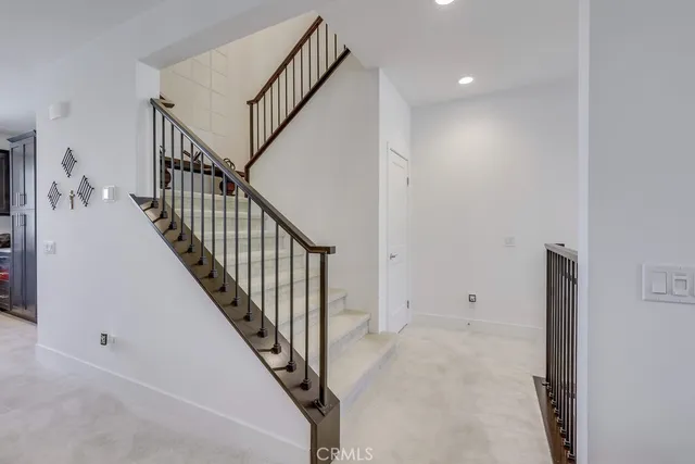 a bedroom with a bed and a lamp on dresser