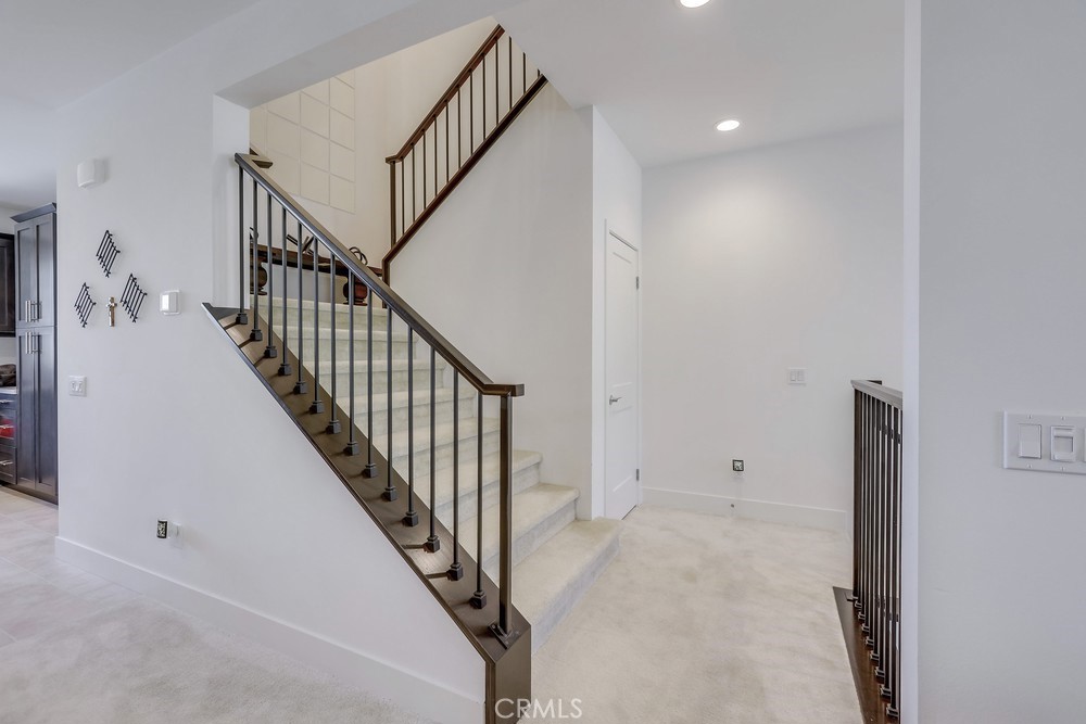 104 Alder Ridge Lake Forest, CA 92610 - Photo 34 of 74 a view of staircase with wooden floor and white walls