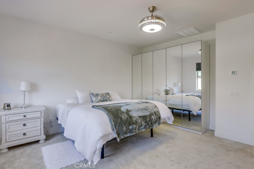 104 Alder Ridge Lake Forest, CA 92610 - Photo 37 of 74 a spacious bedroom with a bed and a cabinets