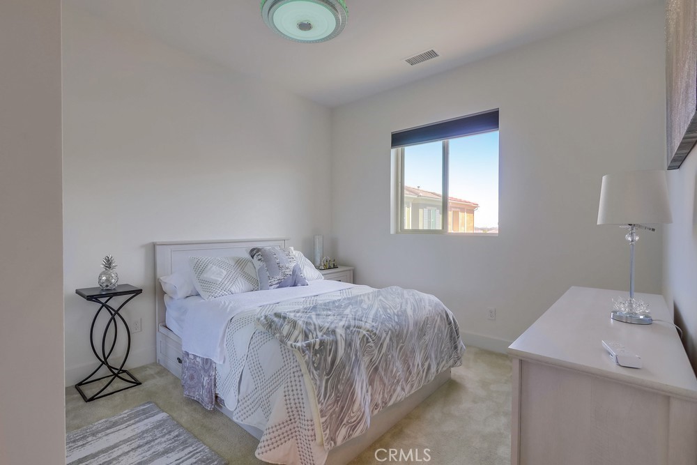 104 Alder Ridge Lake Forest, CA 92610 - Photo 43 of 74 a bedroom with a bed and a table in it