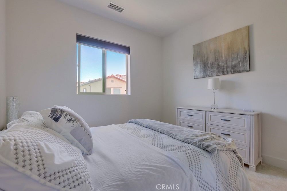 104 Alder Ridge Lake Forest, CA 92610 - Photo 44 of 74 a bedroom with a bed and a window