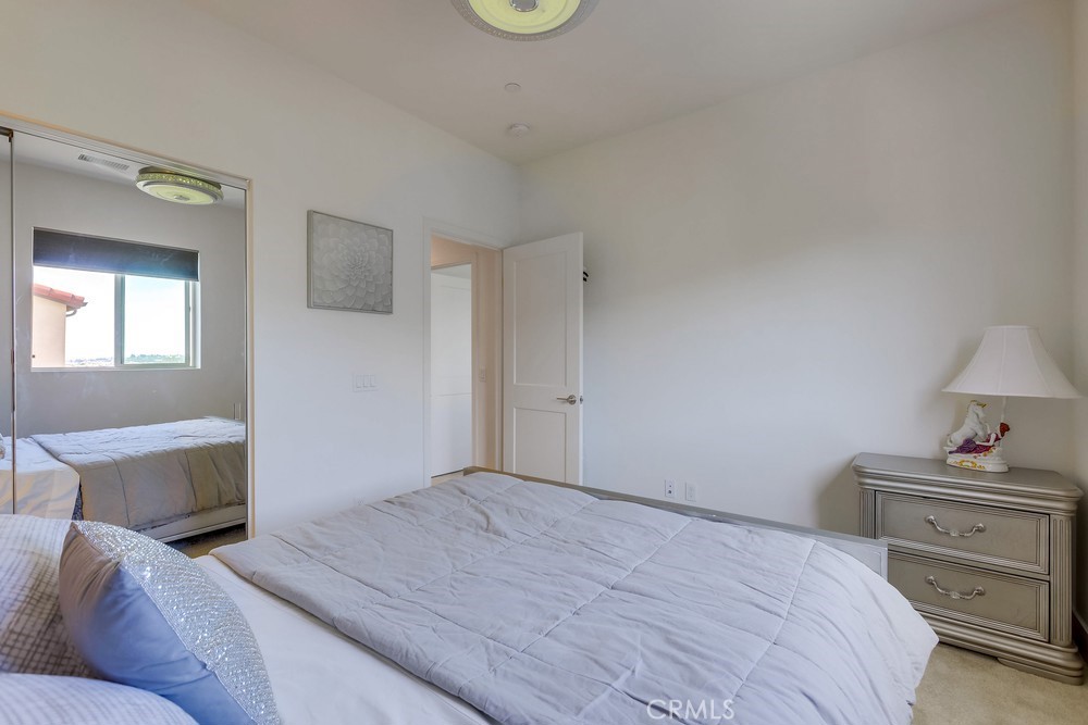 104 Alder Ridge Lake Forest, CA 92610 - Photo 45 of 74 a bedroom with a bed and a lamp on dresser