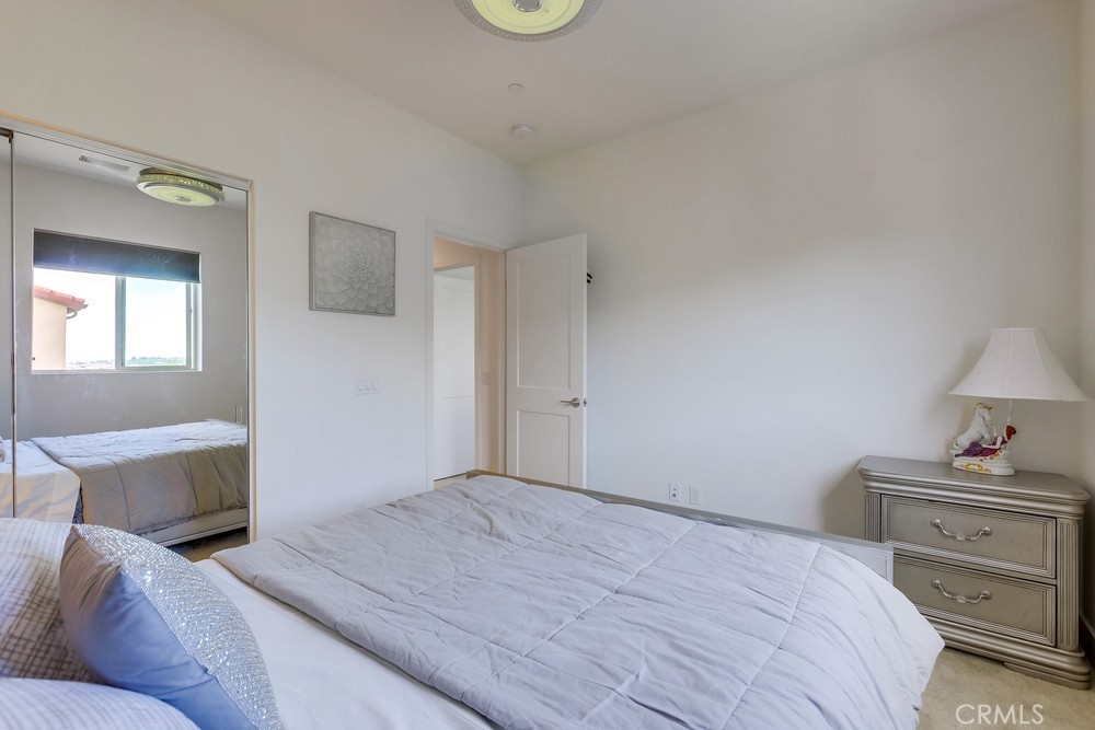 104 Alder Ridge Lake Forest, CA 92610 - Photo 51 of 74 a bedroom with a bed and a lamp on dresser