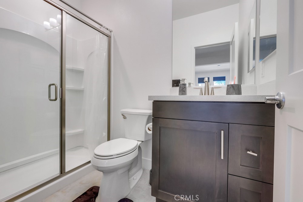 104 Alder Ridge Lake Forest, CA 92610 - Photo 56 of 74 a bathroom with a sink a toilet and a mirror