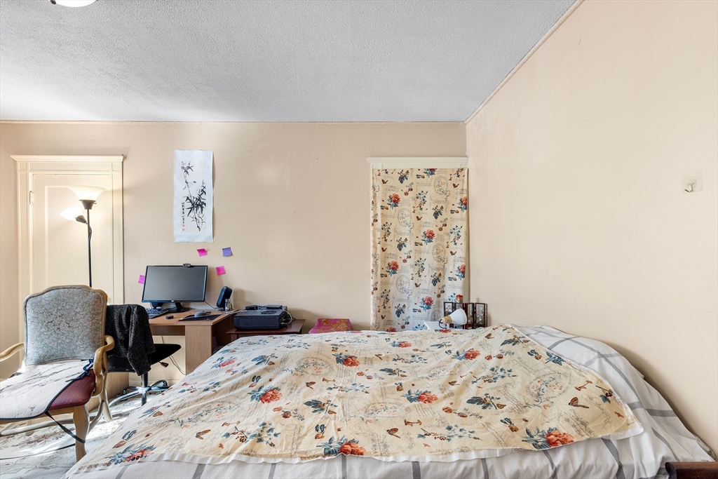 8 Walnut Street, Unit 5 Everett, MA 02149 - Photo 7 of 13 a bedroom with a bed and wooden floor