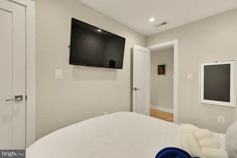a bedroom with a bed and a flat screen tv