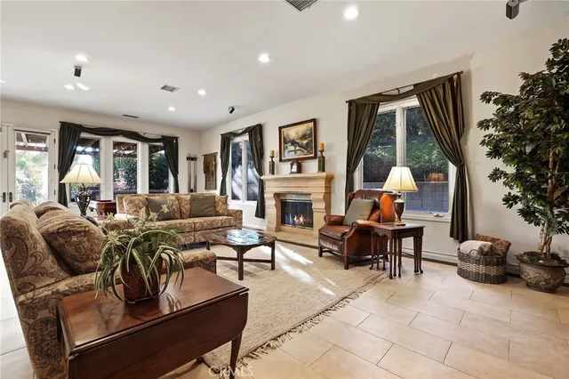 a living room with furniture fireplace and flat screen tv