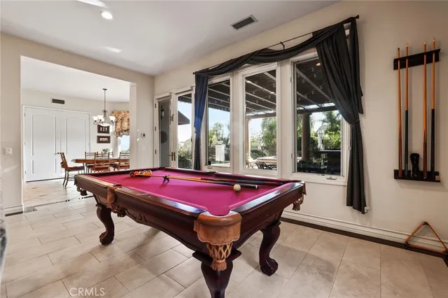 a room with furniture a flat screen tv and a pool table