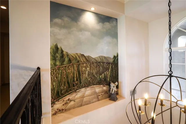 a white bed sitting in a room next to a window