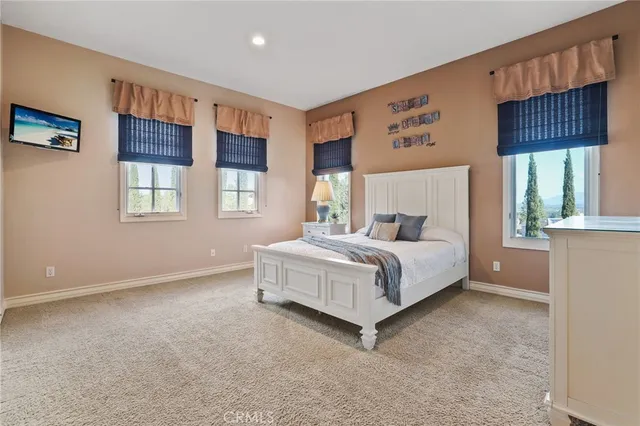 a bathroom with a granite countertop sink toilet a large mirror a shower and a bathtub