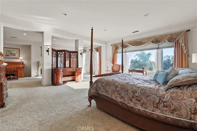a living room with furniture a flat screen tv and a large window