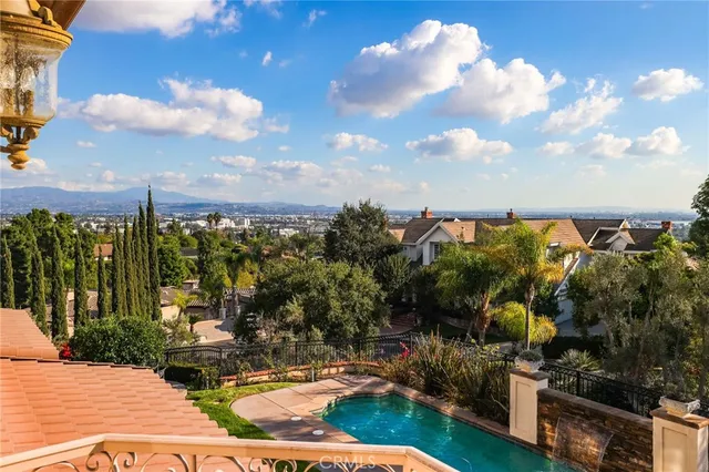 a patio with table and chairs and potted plants