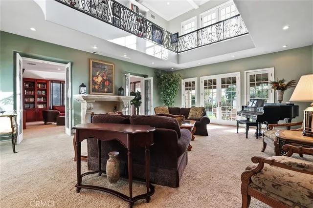 a living room with furniture a piano and a fireplace