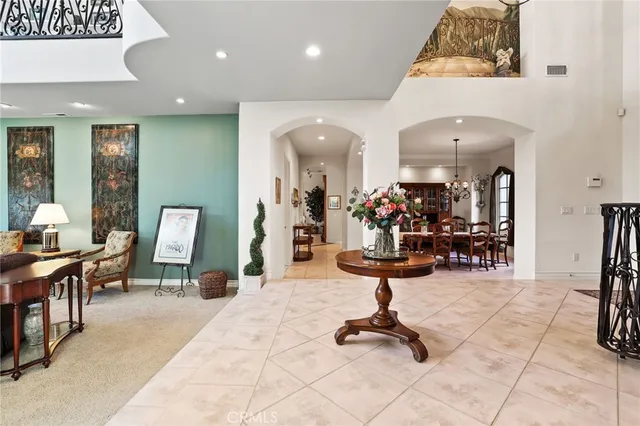 a view of a dining room with furniture and chandelier