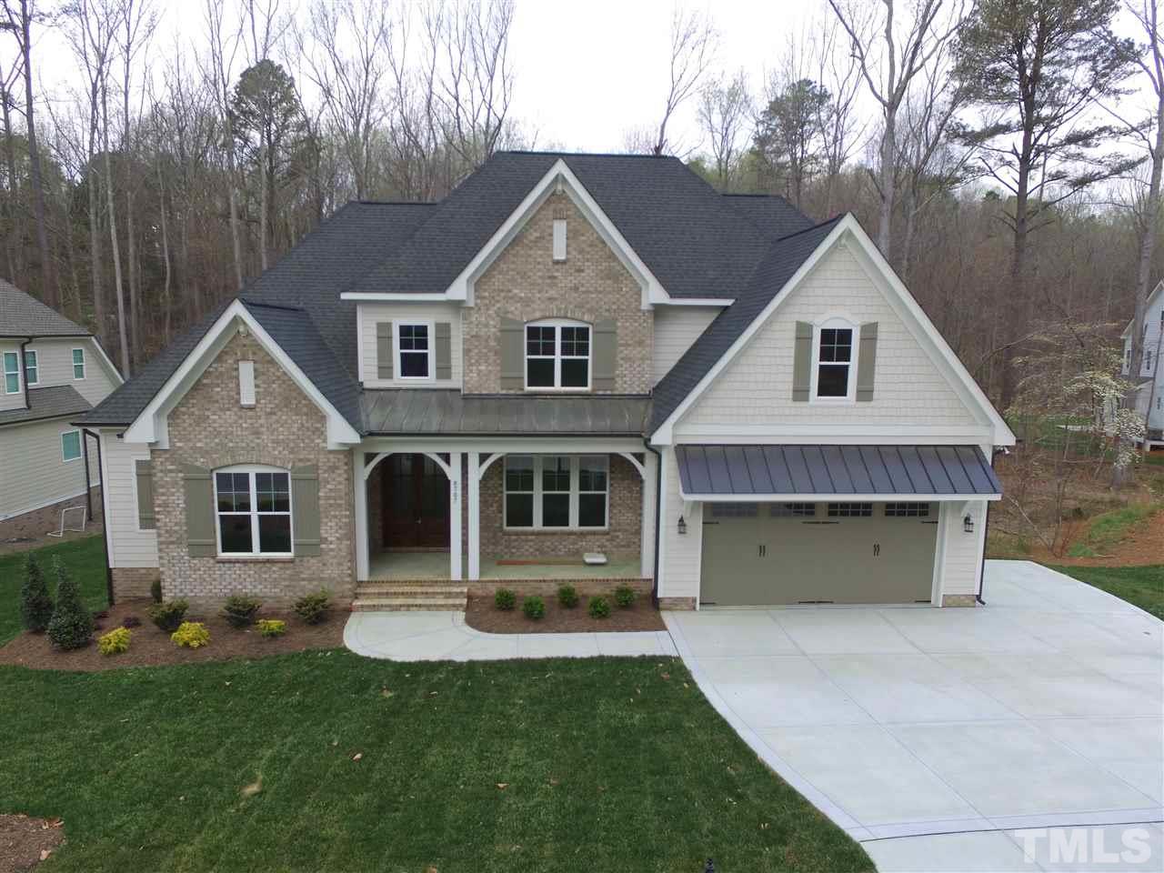 8707 Duckview Court Raleigh, NC 27613 - Photo 1 of 25 a front view of a house with a yard and garage