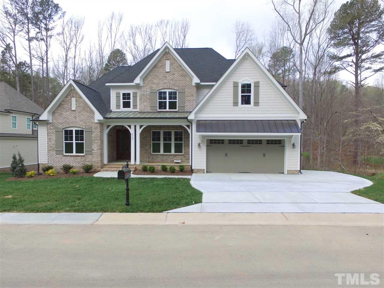 8707 Duckview Court Raleigh, NC 27613 - Photo 2 of 25 a front view of a house with a garden and garage