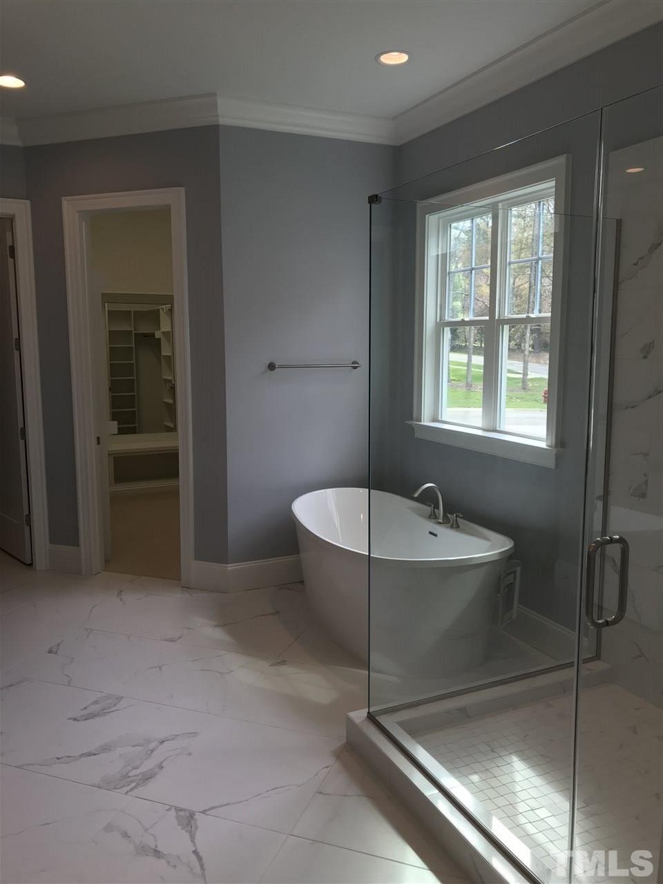 8707 Duckview Court Raleigh, NC 27613 - Photo 12 of 25 a spacious bathroom with a tub and shower