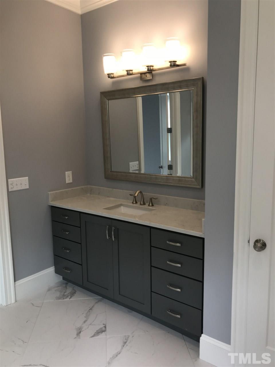 8707 Duckview Court Raleigh, NC 27613 - Photo 13 of 25 a bathroom with a sink and a mirror