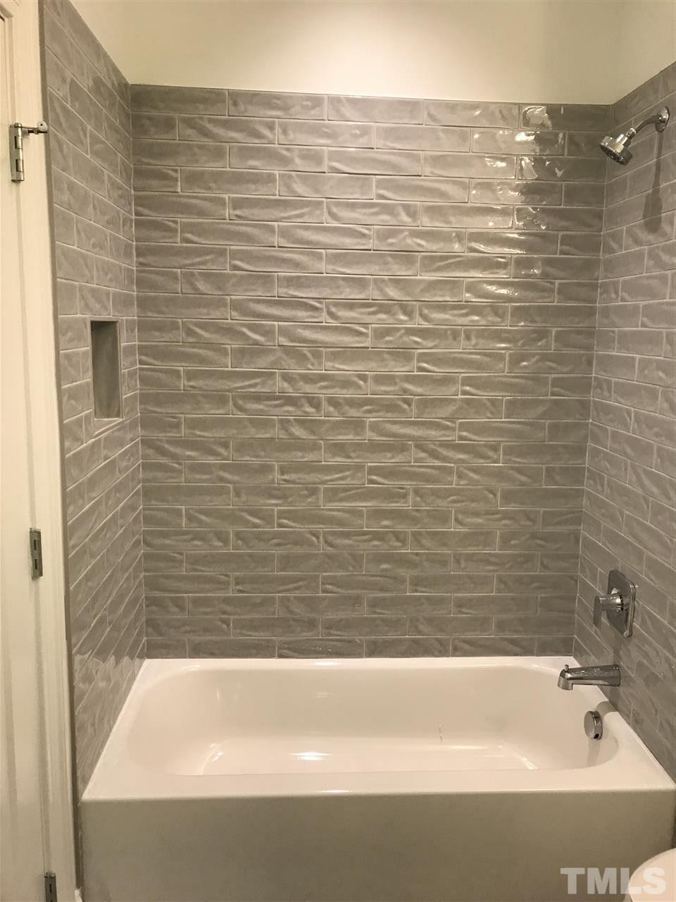 8707 Duckview Court Raleigh, NC 27613 - Photo 16 of 25 a bathroom with a bathtub