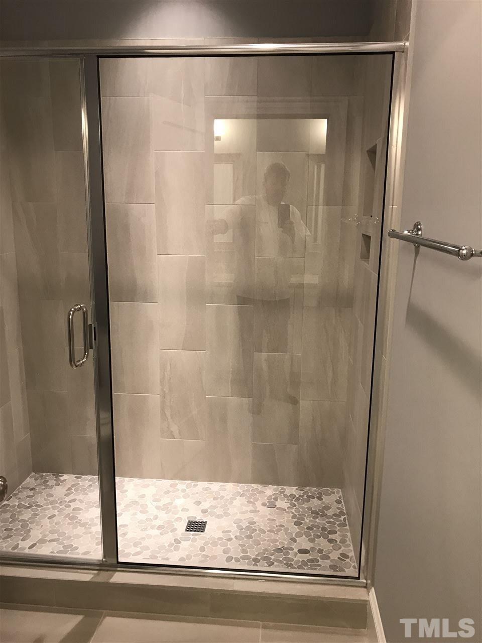8707 Duckview Court Raleigh, NC 27613 - Photo 18 of 25 a bathroom with a glass shower door
