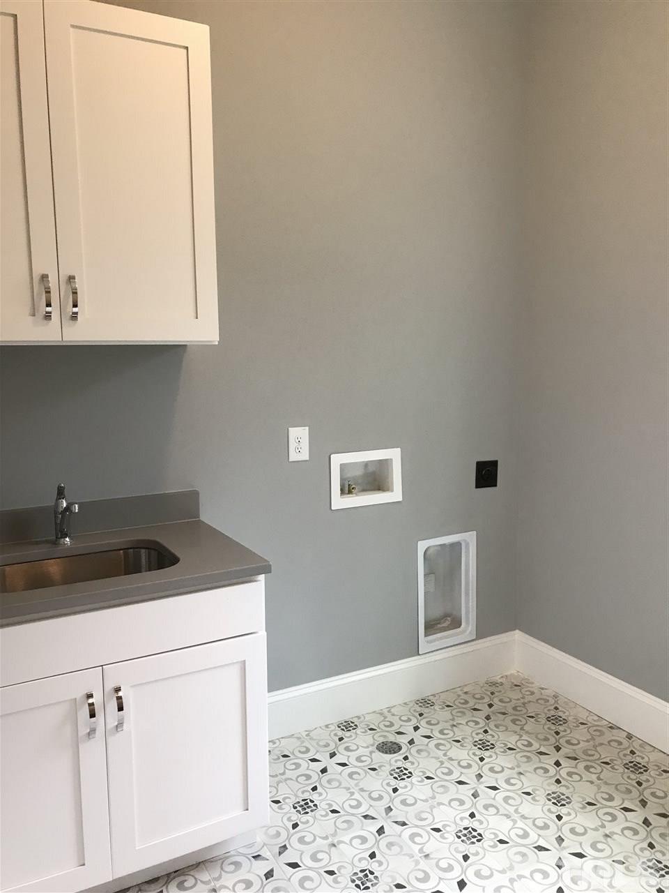 8707 Duckview Court Raleigh, NC 27613 - Photo 20 of 25 a kitchen with a sink and cabinets