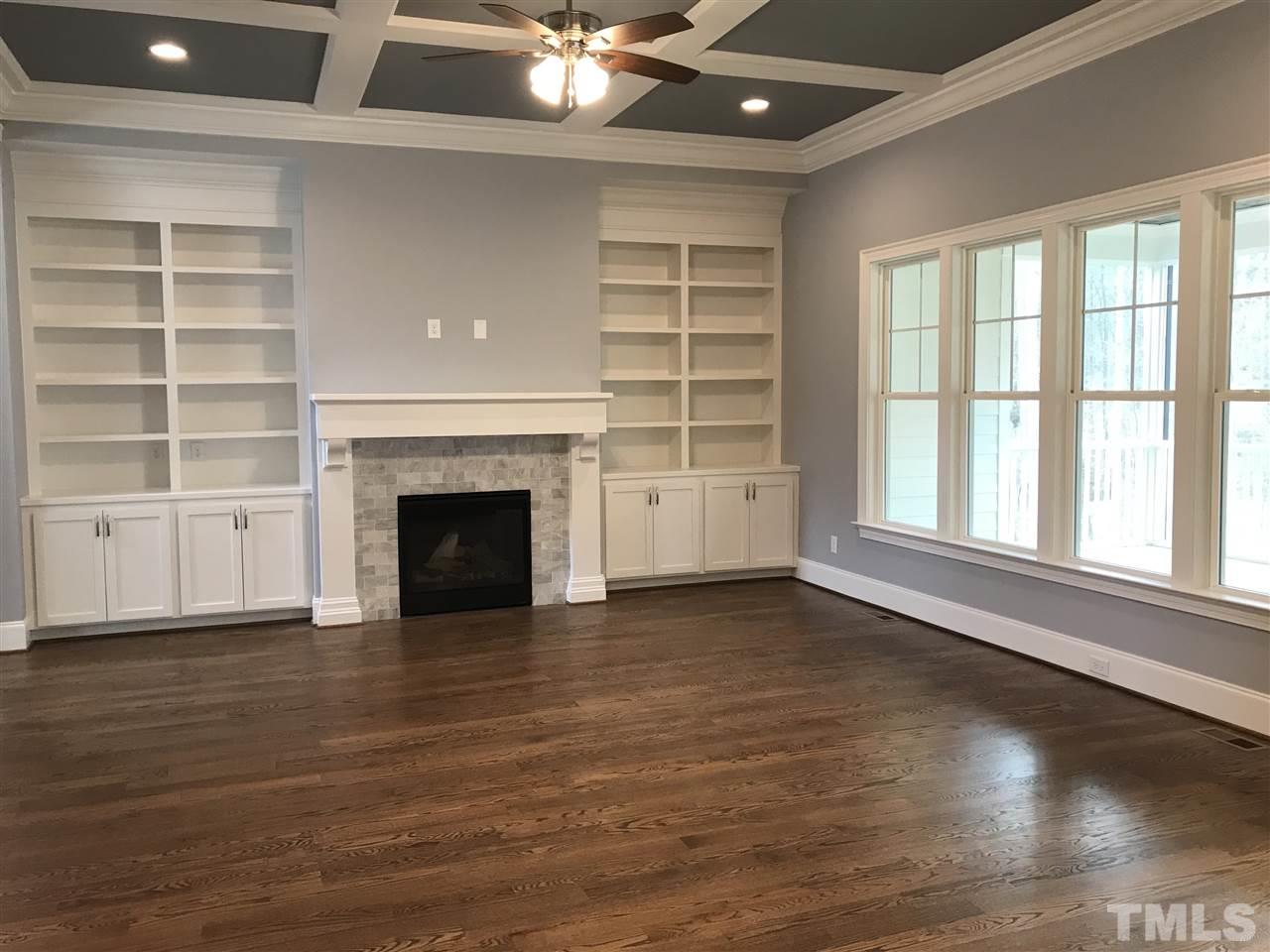 8707 Duckview Court Raleigh, NC 27613 - Photo 6 of 25 wooden floor fireplace and windows in an empty room