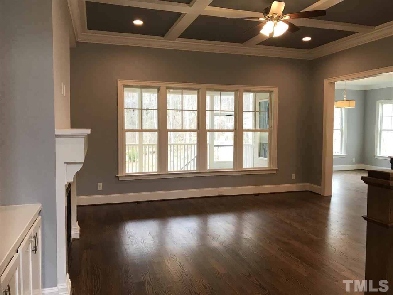 8707 Duckview Court Raleigh, NC 27613 - Photo 7 of 25 a view of an empty room with wooden floor and a window