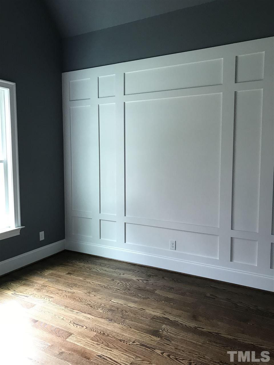 8707 Duckview Court Raleigh, NC 27613 - Photo 10 of 25 a view of an empty room with wooden floor and a window