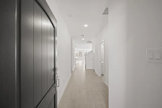 a view of a hallway with wooden shelves