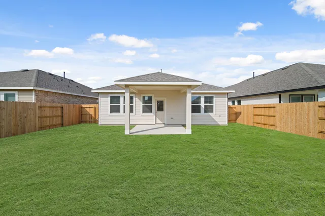 a kitchen with stainless steel appliances kitchen island granite countertop a dining table chairs and white cabinets