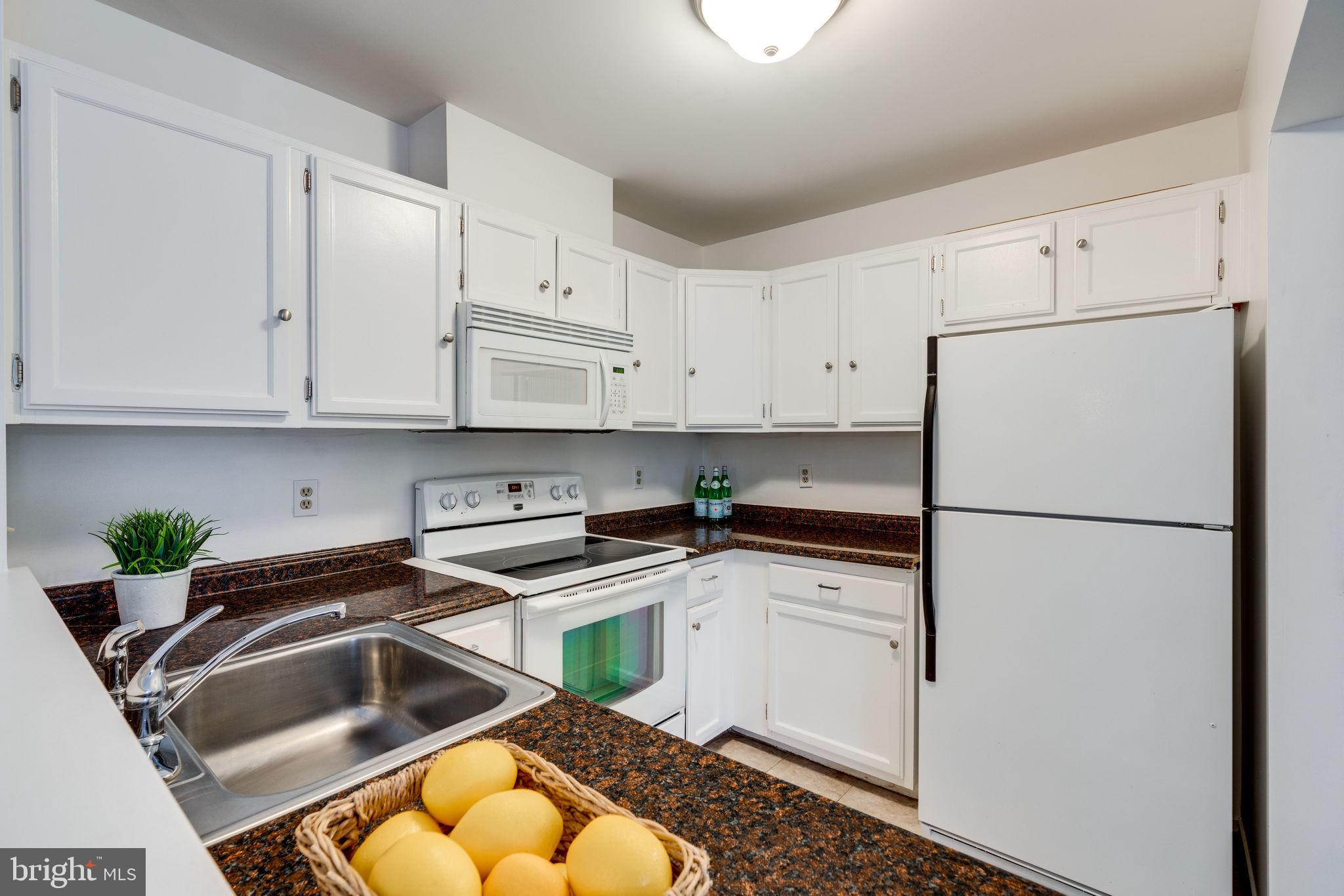 7800 D Harrowgate Circle, Unit 130 Springfield, VA 22152 - Photo 17 of 48 Crisp white cabinets and appliances