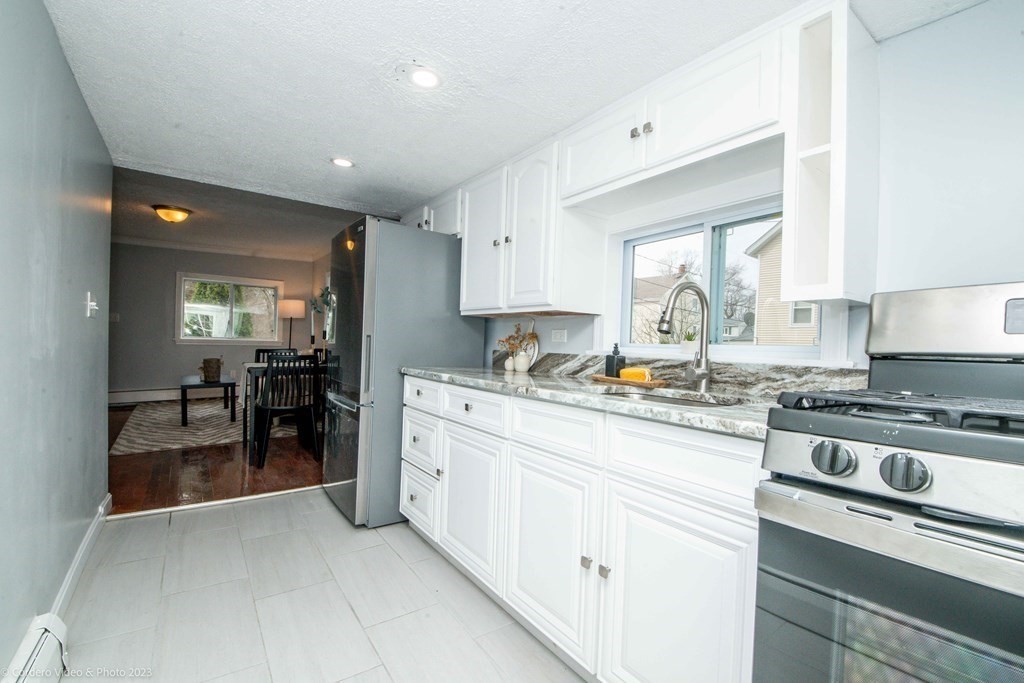 452 Tecumseh Street Fall River, MA 02721 - Photo 14 of 26 a kitchen with appliances a sink and cabinets