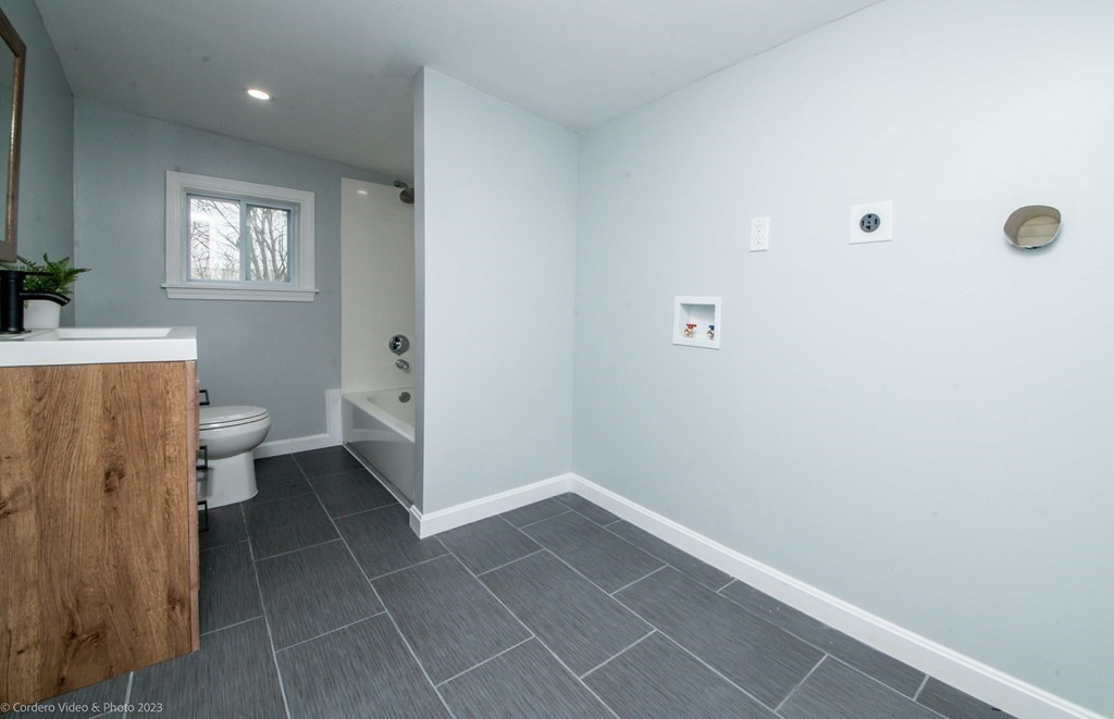452 Tecumseh Street Fall River, MA 02721 - Photo 15 of 26 a bathroom with a sink a toilet and a mirror