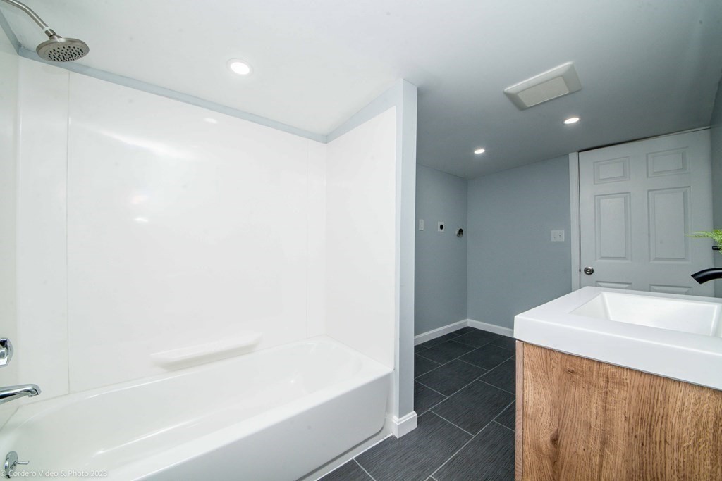 452 Tecumseh Street Fall River, MA 02721 - Photo 17 of 26 a bathroom with a bathtub and a sink