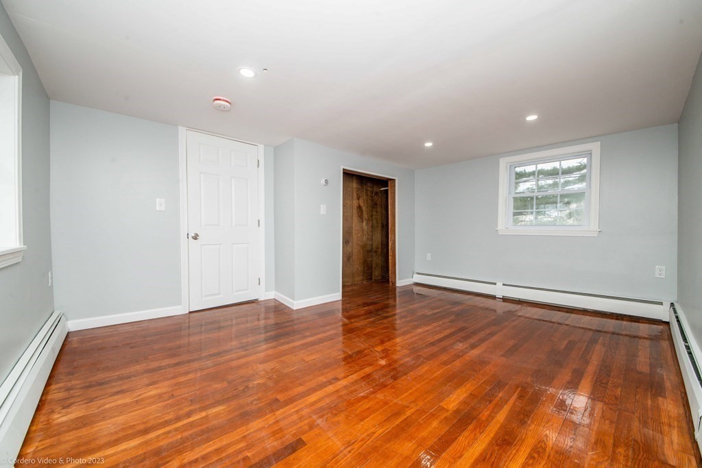 452 Tecumseh Street Fall River, MA 02721 - Photo 24 of 26 an empty room with wooden floor and windows