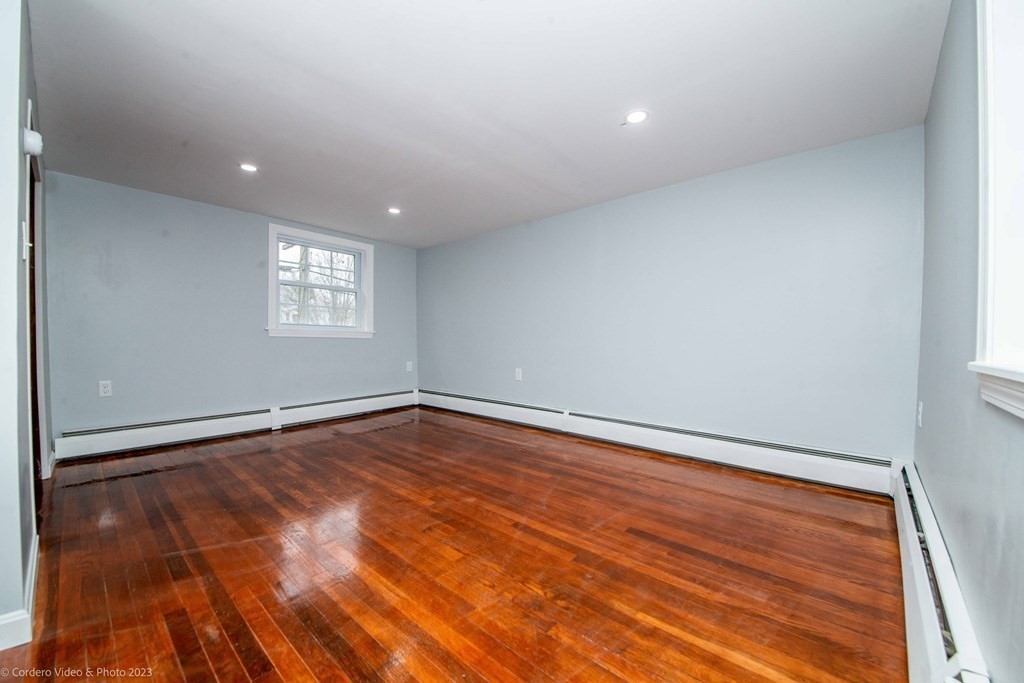 452 Tecumseh Street Fall River, MA 02721 - Photo 26 of 26 a view of an empty room with wooden floor and a window