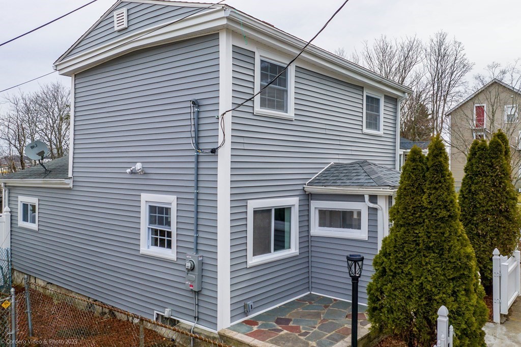 452 Tecumseh Street Fall River, MA 02721 - Photo 3 of 26 a view of a house with a small yard and plants