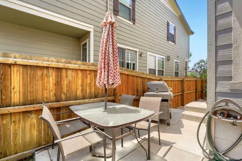 a balcony with table and chairs