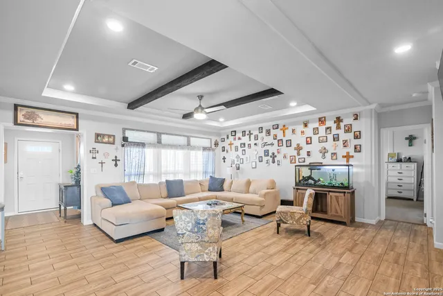 a living room with furniture and wooden floor