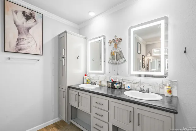 a bathroom with a double vanity sink and a mirror